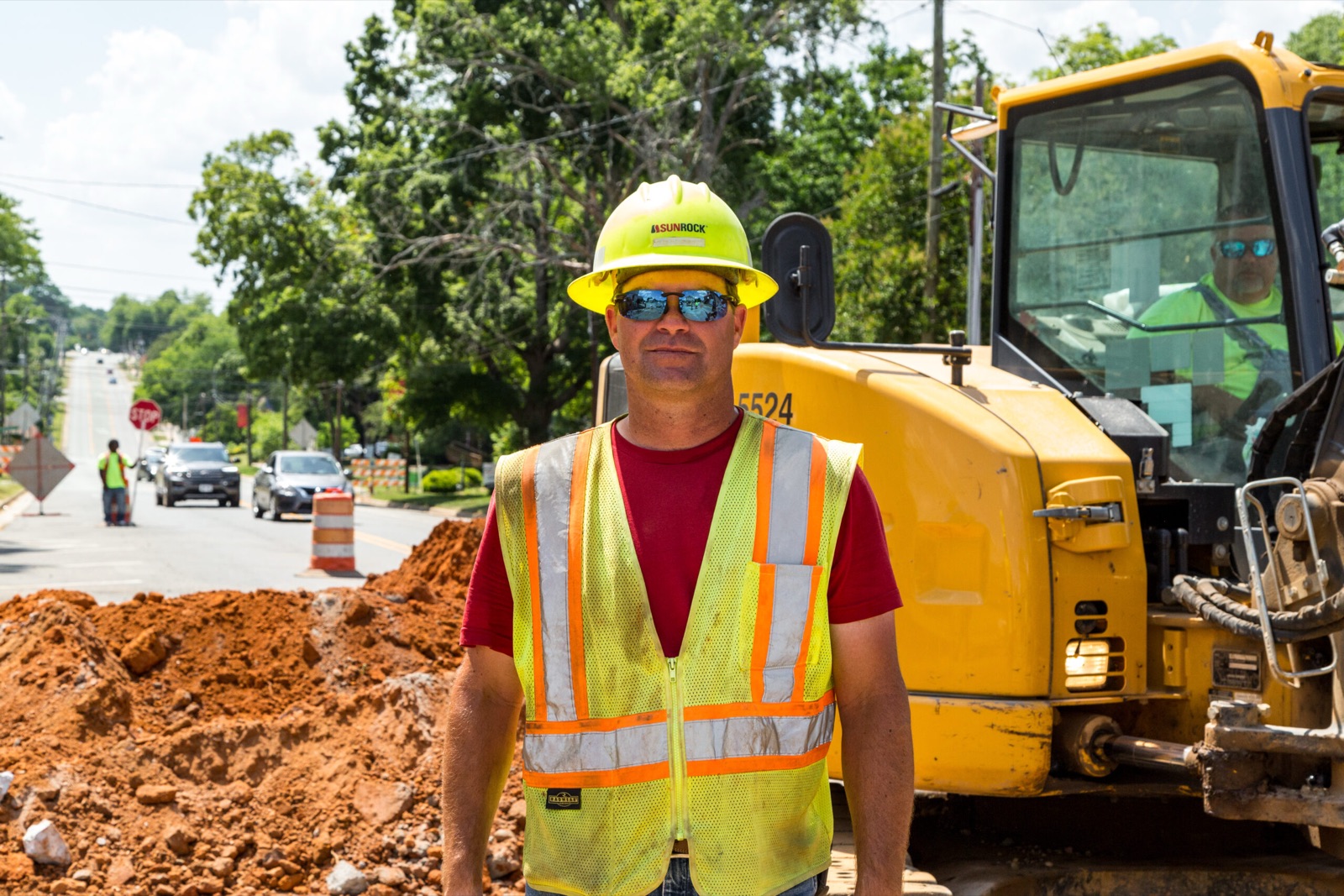 Sunrock operator in front of his excavator